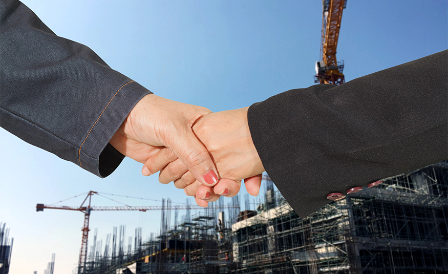 Handshake in a business and deal at construction site